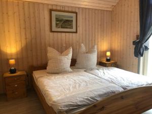 a bedroom with a bed with white sheets and pillows at Seeschwalbe Classic 226 in Mirow