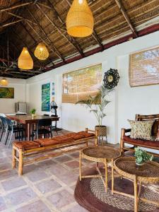 a living room with wooden furniture and a table at Balai Roco in Bauang