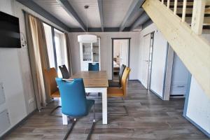 a dining room with a table and chairs at Seeschwalbe Classic 310 in Mirow +2 photos