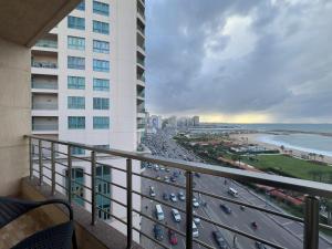 a balcony with a view of the beach and buildings at Nabeel Homes Boutique Hotel - G2 in Alexandria