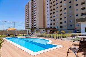 a swimming pool in front of a building at Super Anfitrião MT - Apartamentos Luxxor Flat in Cuiabá