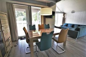 a dining room and living room with a table and chairs at Seeschwalbe Classic 322 in Mirow