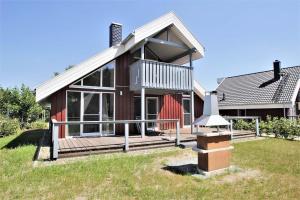 a home with a large deck and a house at Seeschwalbe Classic 322 in Mirow