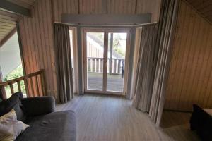 a living room with a sliding glass door at Wildgans Classic 247 in Mirow
