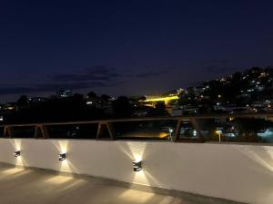 a balcony with lights on it at night at SUITE Família com criancas in Teófilo Otoni