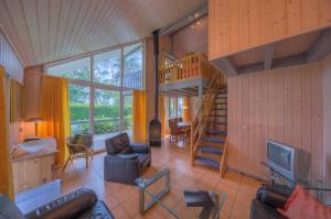 a living room with a staircase in a house at Wildgans Classic 252 in Mirow