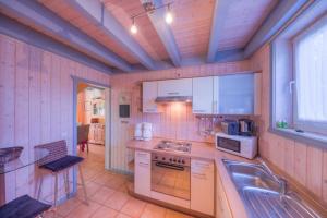 a kitchen with a sink and a stove top oven at Wildgans Classic 252 in Mirow