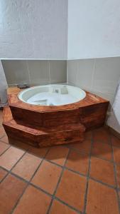 bañera de madera en una habitación en HOSTERÍA BRISAS DEL RÍO, en Marinilla