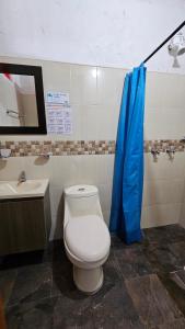 a bathroom with a toilet and a sink at HOSTERÍA BRISAS DEL RÍO in Marinilla