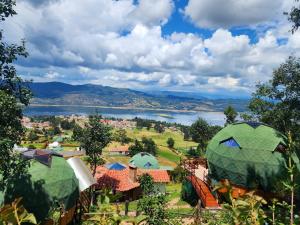 a view of a park with tents and a lake at Glamping sede campestre Mirador de Pueblo Viejo in Guatavita
