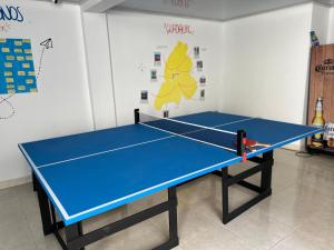 a blue ping pong table in a room at Los Nonos Hostel in Guadalupe