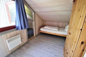 a small room with a bed and a window at Wildgans 5A in Mirow +2 photos