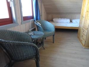 um quarto com duas cadeiras, uma cama e uma mesa em Wildgans 114 em Mirow