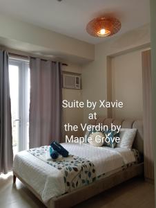 a bedroom with a bed with the words settle by xylele at the ver at Suite by Xavie The Verdin by MAPLE Grove in General Trias +15 photos