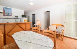 a kitchen and living room with a table and chairs at 2 Bedroom Lovely Home In Piscia Rossa in Afa
