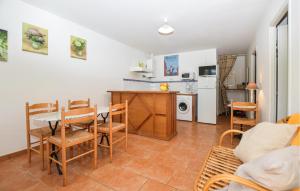 a kitchen and living room with a table and chairs at 2 Bedroom Lovely Home In Piscia Rossa in Afa