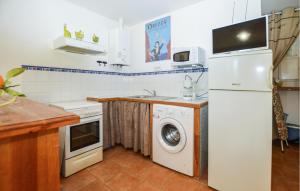a kitchen with a white refrigerator and a washing machine at 2 Bedroom Lovely Home In Piscia Rossa in Afa