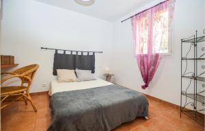 a bedroom with a bed and a chair and a window at 2 Bedroom Lovely Home In Piscia Rossa in Afa