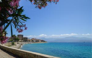 a view of a beach with blue water and buildings at 2 Bedroom Lovely Home In Piscia Rossa in Afa