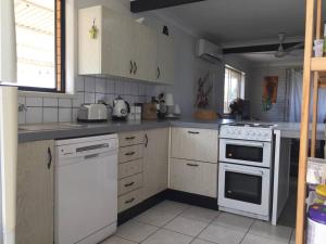 a kitchen with a white stove and white appliances at McMansion: Sleeps 6, Walk to Beach, Pet Friendly in Golden Beach