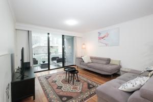 a living room with a couch and a tv at Fantastic 3 Bds apartment Darling Harbour & Fish Market & Chinatown & Casino & Central in Sydney