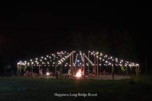 um grupo de luzes num parque à noite em Happiness Long Bridge Resort 