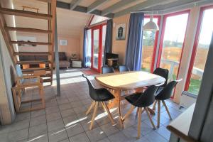 a dining room with a table and chairs in a house at Wildgans 274 in Mirow