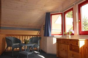 a room with two chairs and a table in a cabin at Wildgans 274 in Mirow