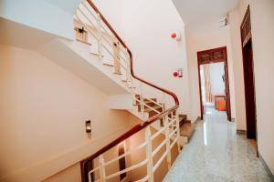 a staircase in a home with white walls at Phú Vang Hotel Pleiku in Pleiku