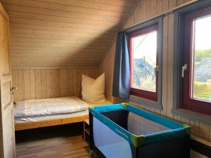 a small room with a small bed in a cabin at Wildgans 41 in Mirow