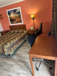 a hotel room with a bed and a table at Budget Inn - Scottsboro in Scottsboro
