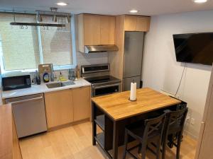 a kitchen with a wooden table with a counter top at Seattle Skyline Retreat Cozy 1BD w Balcony Views in Seattle