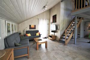 a living room with a couch and a staircase at Wildgans 267 in Mirow