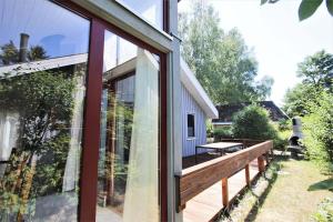 a glass extension to a house with a deck at Wildgans 267 in Mirow
