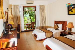 Ein Bett oder Betten in einem Zimmer der Unterkunft Sun Spa Resort & Villa