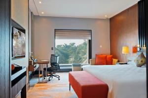 a hotel room with a large bed and a desk at Sama Sama Hotel KLIA in Sepang +30 photos