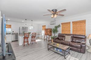 a living room with a couch and a kitchen at Beachside Retreat - Garden City - Murrells Inlet in Myrtle Beach