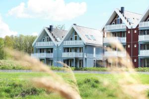 a row of houses with grass in front of them at Kapitänsdeck 534 in Rechlin