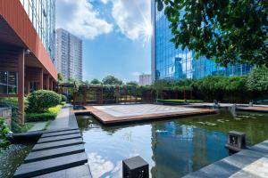 a pond in the middle of a city with tall buildings at Sheraton Changsha Hotel in Changsha