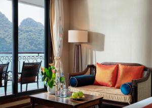 a living room with a couch and a table at Indochine Cruise Lan Ha Bay Powered by ASTON in Ha Long