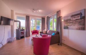 a living room with a couch and a table at Gartendeck 532 in Rechlin