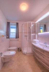 a bathroom with a shower and a toilet and a sink at Gartendeck 532 in Rechlin +5 photos
