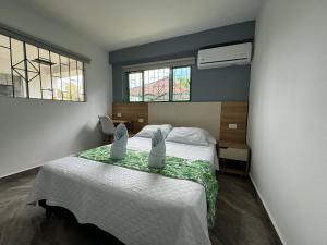 Postel nebo postele na pokoji v ubytování Hotel Maratea Melgar