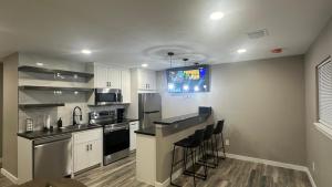 a kitchen with white cabinets and black counter tops at Apt 6 - High Plains Lodge at Nomad Landing in Clayton