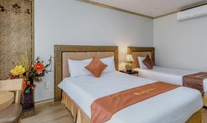a hotel room with two beds and a chair at Pearly Hotel in Jeju