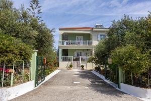 a house with a gate and a driveway at SEA & OLIVES HOUSE in Lixouri
