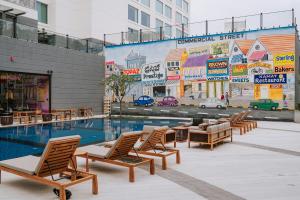 The swimming pool at or close to Moxy Bengaluru Airport Prestige Tech Cloud