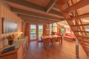 a kitchen and dining room with a table and chairs at Wildgans Classic 29 in Rechlin