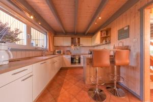 a large kitchen with white cabinets and a counter at Wildgans Classic 29 in Rechlin