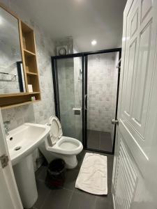 a bathroom with a shower and a toilet and a sink at The Northern MFU in Ban Pa Toem